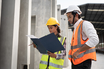 Working India engineer woman use document and talking with Asia engineer man at precast site work