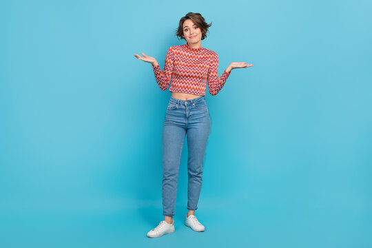Photo cute lady indifferent expression emotion shrug shoulders stupid wear shirt pants sneakers isolated blue color background