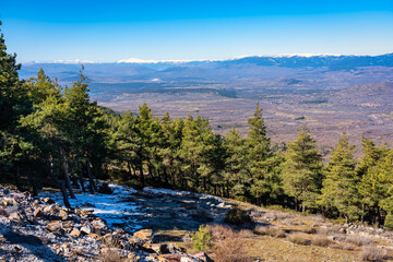 Panorama of green landscape of mountain range with snowy peaks, Guadarrama, Madrid, Spain.