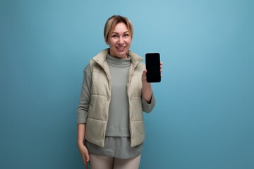 blonde young woman showing smartphone mockup