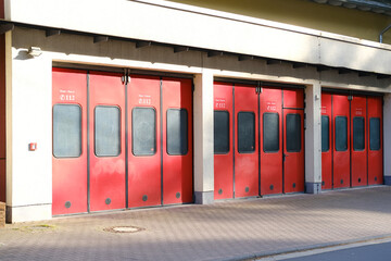row of vintage red retro fire station doors in vintage style, duty dispatcher, fire trucks and...