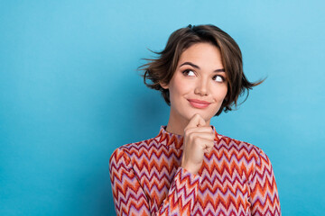 Closeup photo charming lady hold arm on chin look empty space mockup interested wear print shirt isolated blue color background - obrazy, fototapety, plakaty
