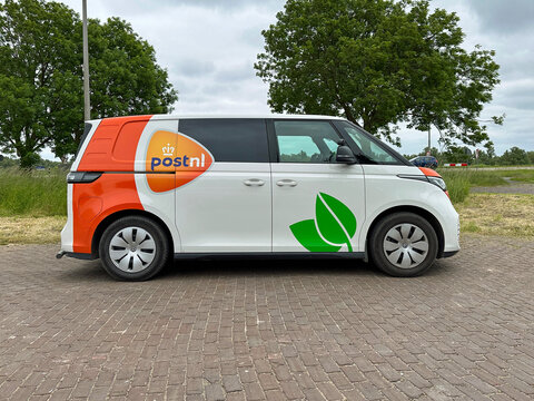 Almere, the Netherlands - May 30, 2023: Dutch PostNL Volkswagen ID. Buzz parked by the side of the road. Nobody in the vehicle.