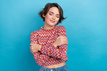 Photo of dreamy sweet lady wear pink shirt closed eyes embracing herself isolated blue color background - obrazy, fototapety, plakaty