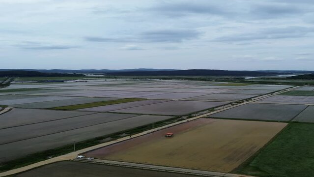 모내기철을 맞이한 바둑판 모양의 논에 물을 대고 흙을 갈아엎는 농기계