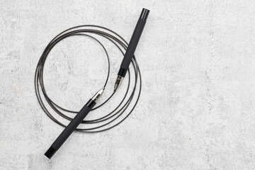 Black fitness skipping rope close-up isolated on white gray background. crossfit sports equipment