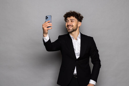 Man making selfie on smartphone camera, blogger communicating, recording video for followers, waving hand, saying hello.