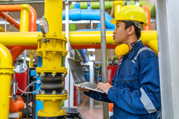 Maintenance technician at a heating plant,Petrochemical workers supervise the operation of gas and oil pipelines in the factory,Engineers put hearing protector At room with many pipes