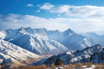 majestic mountain landscape with snow-covered peaks and blue sky, created with generative ai