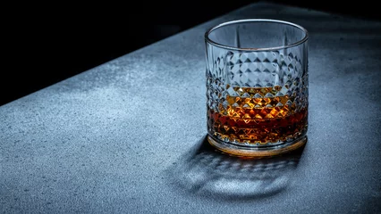 Gordijnen Glass of scotch whiskey, Hard strong alcoholic drink, place for text, top view © Надія Коваль