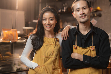 Opening a small entrepreneur business, Happy young Asian woman barista in an apron near a coffee...