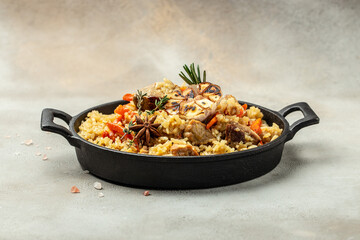 Uzbek pilaf in cast-iron pan. banner, menu, recipe place for text, top view