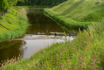 Fototapeta na wymiar 29 May, 2023, Halsteren, Netherlands Moses bridge, a sunken pedestrian bridge in a moat, in Fort De Roovere