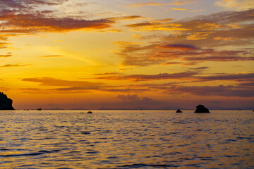 Sea among rocks on evening sunset. Island in tropical waters at Andaman sea Thailand. Summer landscape.