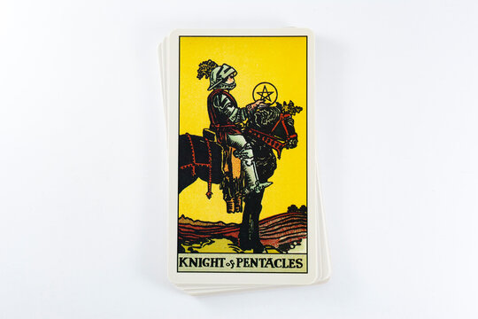 Madrid, Spain - May 22, 2023: Tarot cards, Rider Waite tarot cards, the knight of pentacles vintage card in the foreground.