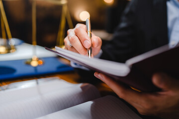 Professional businessman executive manager hand filling approval paper business document, using pen to signing signature on contract of partnership agreement and working on desk in modern office