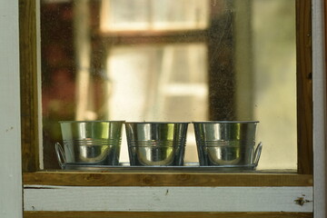 pots through greenhouse window
