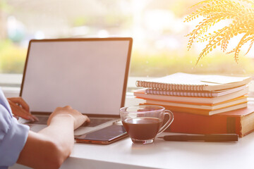 Young Asian businesswoman using laptop and notebook computers to work through internet to collect and organize investment documents. young businesswoman concept using technology to help investment