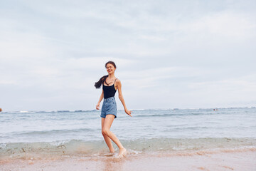 Fototapeta na wymiar lifestyle woman travel young summer active sunset running smile sea beach