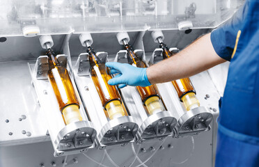 Worker working on Brewery factory plant production line, top view. Disinfection and pasteurization...