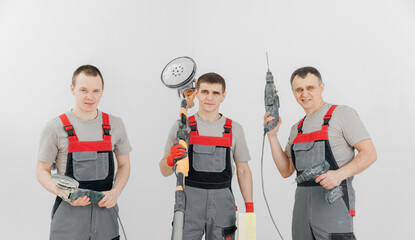 Team builders happy mans with equipments drill for renovation apartments, isolated on white...