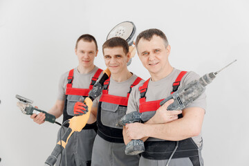 Team builders happy mans with equipments drill for renovation apartments, isolated on white...