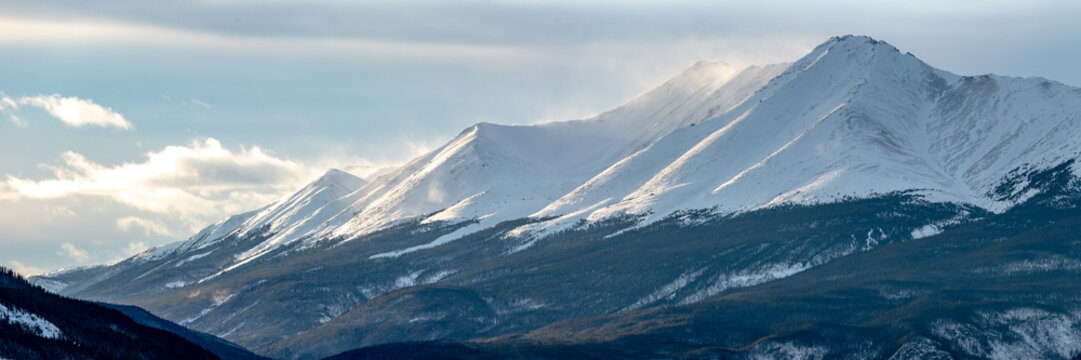 Winter mountain landscape views near Banff National Park in November with huge snow capped mountains and bucket list scenery in Canada. 