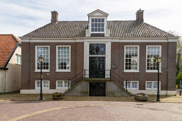 Fototapeta na wymiar Former 18th century town hall in the Dutch village of Hoogwoud. 