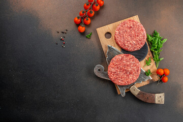 Raw cutlet for burger on a dark background, Restaurant menu, dieting, cookbook recipe top view