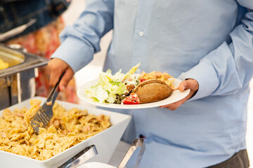 person holding a plate with food