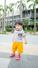 A Malay boy wearing stripes clothes and yellow pants at the bay