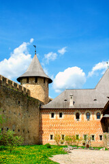 Fototapeta na wymiar Courtyard and part of the wall of old castle. Ukraine, Eastern Europe. The architecture of the Middle Ages in our time. High quality photo
