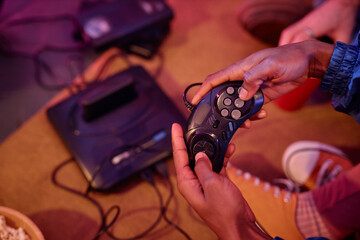 Top view closeup of black young man playing retro video game 80s style, copy space