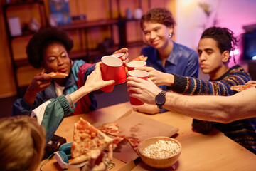 Close up of young people toasting with red cups over table at retro house party, copy space