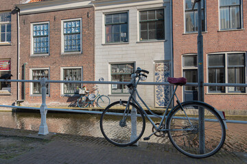 Fototapeta na wymiar Canals, Brick Houses, Parked Bicycles in Delft, Netherlands