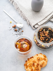 A glass of herbal tea and homemade cookies on a blue background. Drink concept for breakfast.