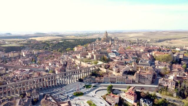 Aerial perspective of Segovia city at sunset. View of aqueduct of Segovia and whole city center. Medieval city situated in Castilla and Leon Province, landmark and travel destination in Spain. Forward