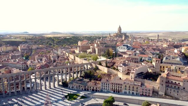 Aerial perspective of Segovia city at sunset. View of aqueduct of Segovia and whole city center. Medieval city situated in Castilla and Leon Province, landmark and travel destination in Spain. Forward