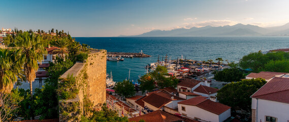 Panorama view from a high point on part of the fortress wall and the old port of Kaleichi in the Turkish city of Antalya. Panoramic view of part of the fortress wall and the old port in the tourist a