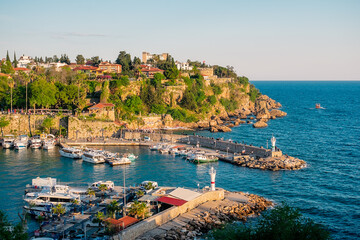 Fototapeta premium View from a height of the harbor near the old town of Kaleichi in the Turkish city of Antalya. Old port in Antalya with many ships and boats. Popular tourist place in Anatalya.