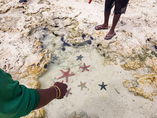 african person showing the starfish