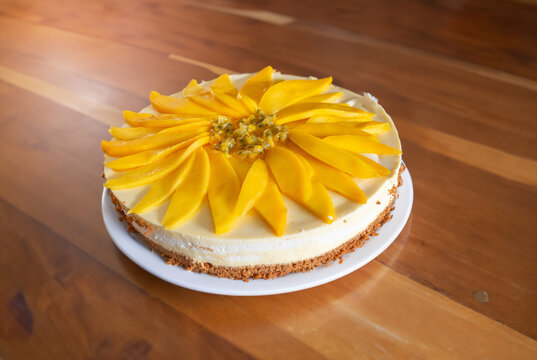 Mango-passionfruit cheesecake on a wooden countertop