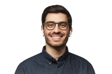 Close-up headshot of young smiling man wearing blue denim shirt, listeting to his favorite music track with earphones