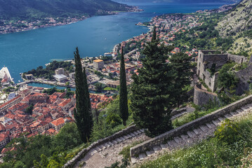 Tourist path to ancient Old Town ruins around St John Fortress above historic part of Kotor town, Montenegro