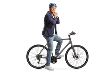 Man with a bicycle putting on a helmet