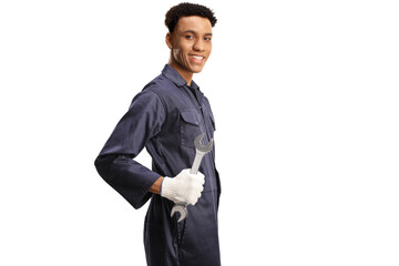 African american car mechanic holding a wrench and smiling
