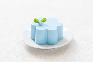 Vegan Blue Matcha cream pudding, Panna Cotta. Creamy dessert with the addition of blue powder of butterfly pea flowers.  White background