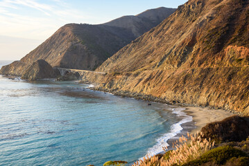 Bridge along the Pacific coast highway one running along the rugged coast of central California at sunset in autumn
