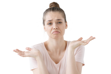 Closeup of emotional young woman isolated on grey background being at a loss, showing helpless gesture with arm and hands, mouth curved as if she does not know what to do with current situation.