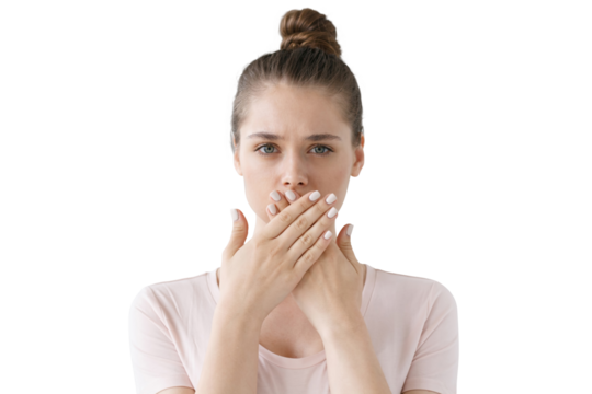Young woman keeping secret, covering mouth with hands